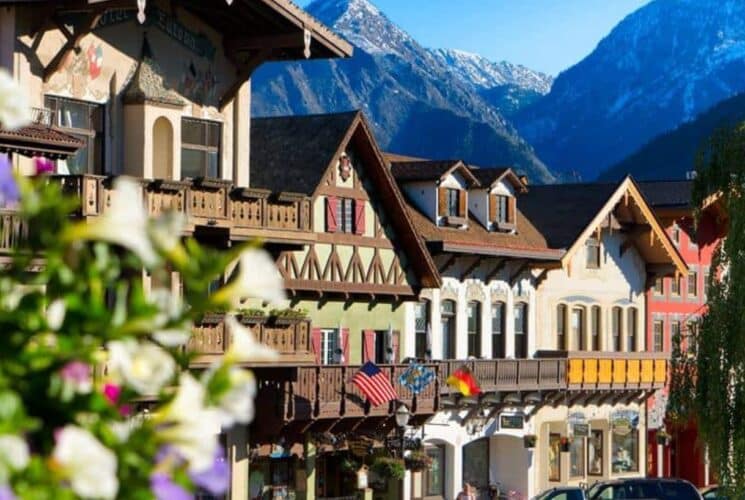 Quaint and colorful buildings in a Bavarian village at the base of a large mountain