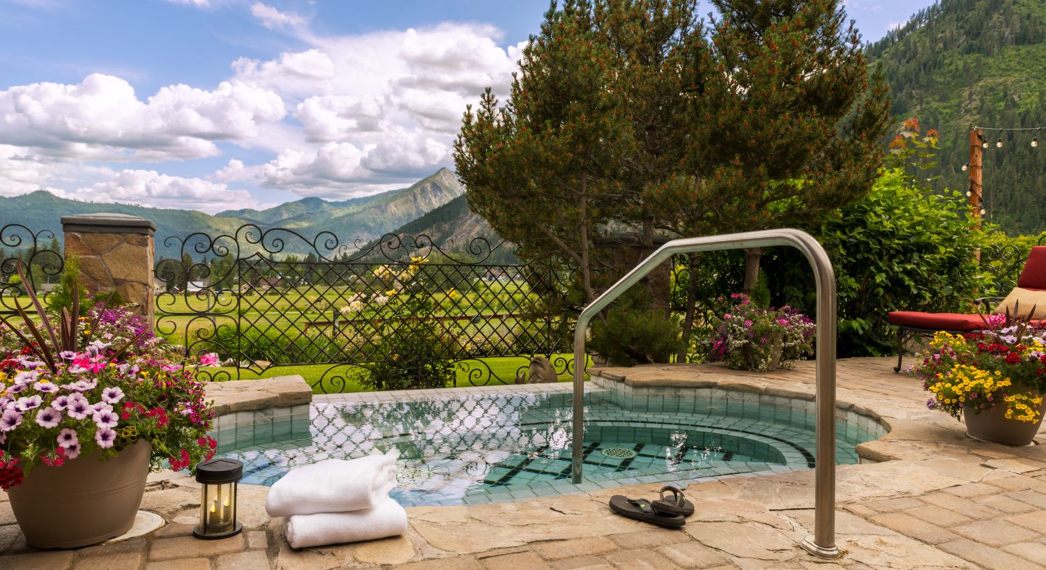 Outdoor hot tub, lounging chairs, overlooking a vast valley and mountain range