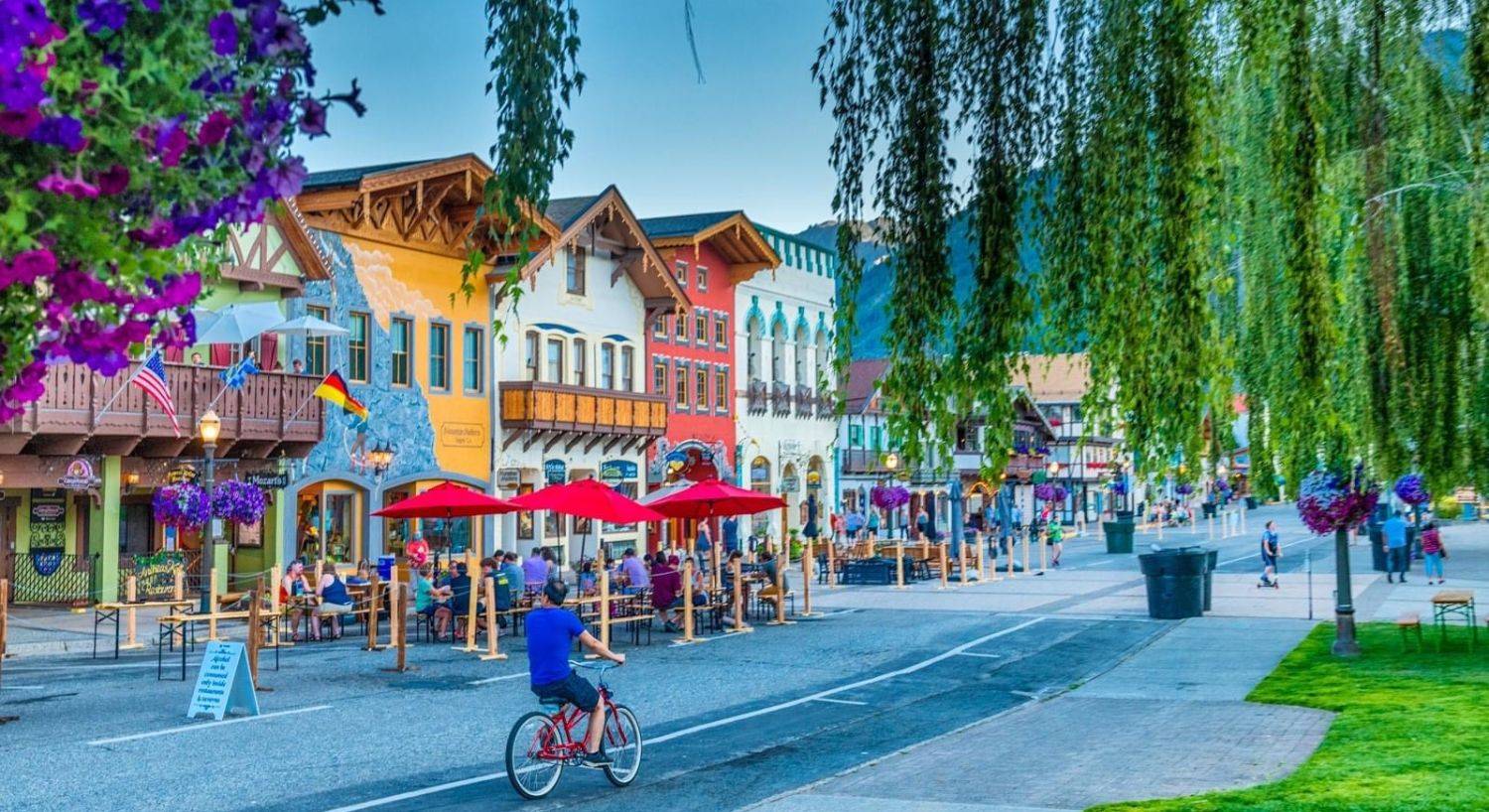 Main street of a quaint Bavarian style mountain town with colorful businesses and outdoor dining